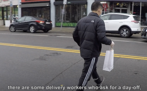 A delivery worker delivers food.