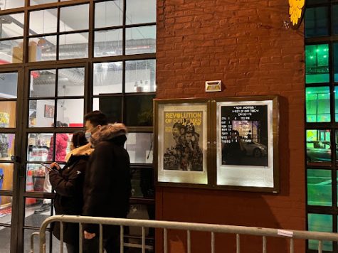 People walk by Stuart Cinema & Cafe in Brooklyn, NY, one of the locations screening a documentary on the 2019 Hong Kong protests.