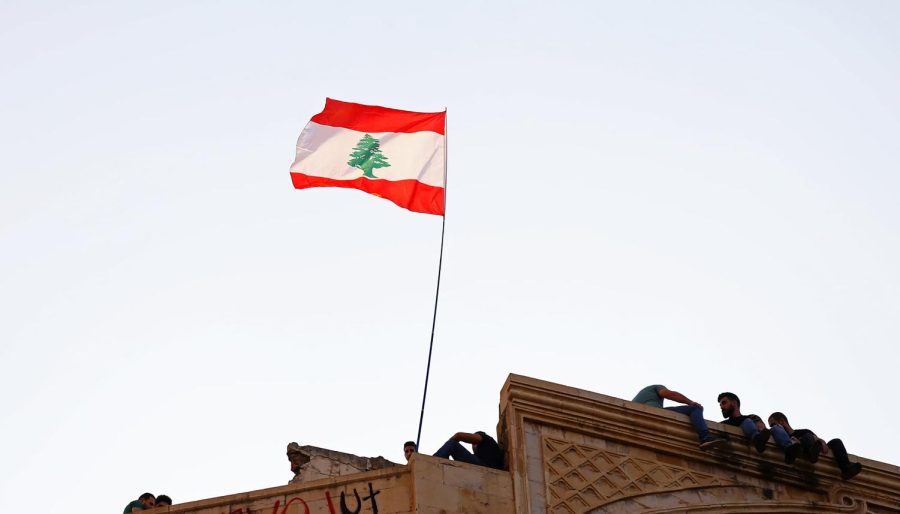  The Lebanese flag on a building during protests in the country’s capital, Beirut. CC: Charbel Karam. 
