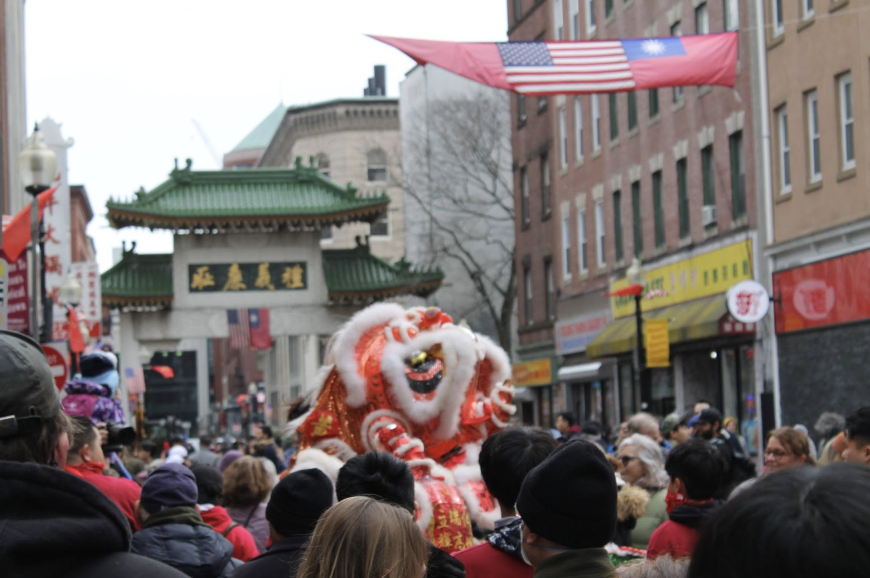 Red in Chinese culture represents good luck, celebration, power, and happiness. A red lion towers over the crowd as performers jump onto each others’ shoulders. 