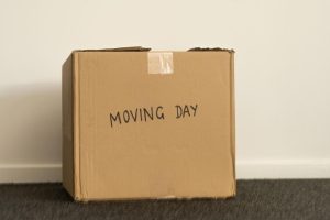 Packing box with moving day written on it