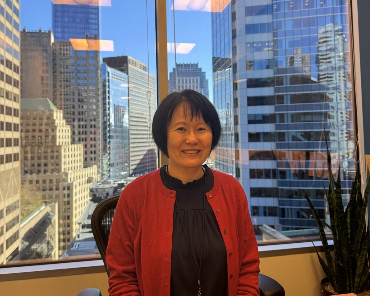 Naoko Takayanagi in a conference room with a panoramic view of downtown Boston. Photo credit: Hikari Terasawa