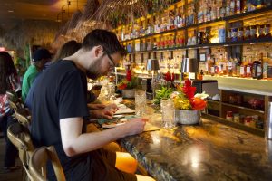 Customers at the Wusong Tiki Bar check out the restaurant menu carefully.